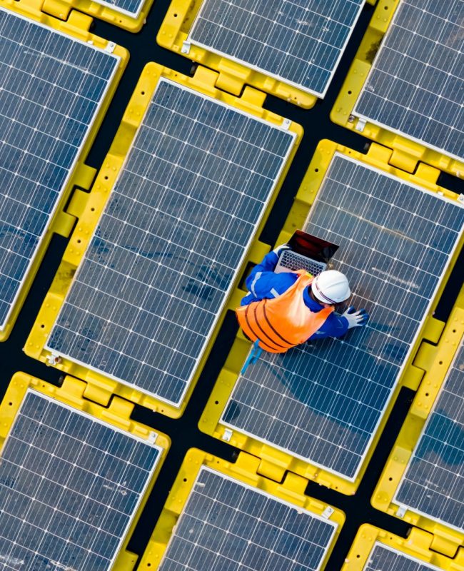 Floating solar panels providing renewable energy. Aerial view floating on solar cells and